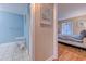 Hallway with access to a blue bathroom and a bedroom with an ocean themed print on the wall at 223 Maisons Dr. # C8, Myrtle Beach, SC 29572