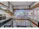 Charming kitchen with white cabinets, stainless steel appliances, and an open view to the dining and living areas at 223 Maisons Dr. # C8, Myrtle Beach, SC 29572