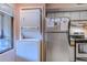 Space-saving kitchen with compact washer/dryer unit next to stainless steel appliances at 223 Maisons Dr. # C8, Myrtle Beach, SC 29572