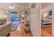Inviting living room flows to screened porch; a bedroom with striped bedding is to the right through a door at 223 Maisons Dr. # C8, Myrtle Beach, SC 29572