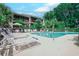 Inviting community pool area with ample lounge chairs and lush landscaping at this condo community at 223 Maisons Dr. # C8, Myrtle Beach, SC 29572