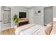 Relaxing main bedroom featuring an en-suite bathroom, TV, and comfortable furnishings at 23 Gabe Pl., Pawleys Island, SC 29585