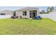 Large backyard with a screened porch, seating, manicured lawn, and privacy fence at 252 Legends Village Loop, Myrtle Beach, SC 29579