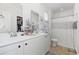 Well-lit bathroom features double sinks, white cabinets and patterned tile flooring at 252 Legends Village Loop, Myrtle Beach, SC 29579