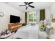 Bright bedroom with green accents, featuring a ceiling fan and sunlit window at 252 Legends Village Loop, Myrtle Beach, SC 29579