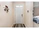 Clean entryway with a white door, coat hooks, and a view into a bedroom at 252 Legends Village Loop, Myrtle Beach, SC 29579