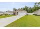 Beautiful home exterior featuring a pristine lawn and a long concrete driveway at 252 Legends Village Loop, Myrtle Beach, SC 29579