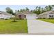 Charming single-story home featuring a well-manicured lawn, concrete driveway, and an attached two-car garage at 252 Legends Village Loop, Myrtle Beach, SC 29579