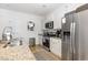 Modern kitchen with stainless steel appliances, granite countertops, and white cabinetry at 252 Legends Village Loop, Myrtle Beach, SC 29579
