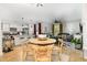Open-concept living space with wood floors, a kitchen island with bar seating, and comfortable seating at 252 Legends Village Loop, Myrtle Beach, SC 29579