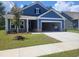 Charming blue single-Gathering home with an attached garage and freshly planted front lawn at 283 River Edge Dr., Myrtle Beach, SC 29588