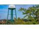 A Conway water tower standing tall on a sunny day. The tank painted with 'Conway' and a picture at 2875 Riverboat Way, Conway, SC 29526