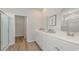 Bathroom with double sinks, framed mirrors, a walk-in shower, and a view into the walk-in closet at 2879 Riverboat Way, Conway, SC 29526