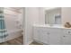 Clean bathroom features white cabinetry, framed mirror, and a shower-tub combo at 2879 Riverboat Way, Conway, SC 29526