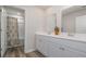 Bright bathroom features double sink vanity with white cabinets and decorative patterned shower curtain at 2879 Riverboat Way, Conway, SC 29526