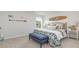 Cozy bedroom with a plush bed, blue bench, nautical decor, and bright window view at 2879 Riverboat Way, Conway, SC 29526
