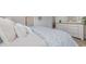 Comfortable bedroom showcases a floral-patterned duvet and dresser with decor, creating a relaxing retreat at 2879 Riverboat Way, Conway, SC 29526