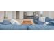 Open living room boasts natural light, and a comfortable blue sectional sofa at 2879 Riverboat Way, Conway, SC 29526