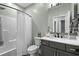 Well-lit bathroom features a shower with white textured curtain, modern vanity, and neutral color scheme at 2909 Moss Bridge Ln., Myrtle Beach, SC 29579