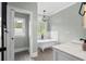 Relax in this stylish bathroom with free-standing tub, chandelier, and natural lighting at 2909 Moss Bridge Ln., Myrtle Beach, SC 29579