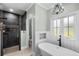 Relax in this stylish bathroom with modern tile shower, free-standing tub and natural lighting at 2909 Moss Bridge Ln., Myrtle Beach, SC 29579