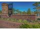 Community entrance sign featuring colorful flowers, a brick base, and manicured landscaping at 2909 Moss Bridge Ln., Myrtle Beach, SC 29579