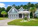 Charming blue two-story home featuring a well-manicured lawn and inviting curb appeal at 2909 Moss Bridge Ln., Myrtle Beach, SC 29579