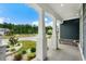 Inviting front porch with stone accents and elegant columns, showcasing neighborhood views at 2909 Moss Bridge Ln., Myrtle Beach, SC 29579