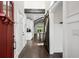 Hallway view with hardwood floors, white trim, and a barn door leading to an open space at 2909 Moss Bridge Ln., Myrtle Beach, SC 29579