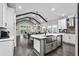 Open-concept kitchen with stainless steel appliances, island sink, and dark hardwood floors at 2909 Moss Bridge Ln., Myrtle Beach, SC 29579
