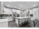 Bright kitchen featuring white cabinets, stainless steel appliances, island with seating, and stylish design at 2909 Moss Bridge Ln., Myrtle Beach, SC 29579