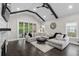 Cozy living room featuring a sectional sofa, sliding doors, and hardwood floors at 2909 Moss Bridge Ln., Myrtle Beach, SC 29579