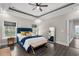 Bright main bedroom showcasing modern ceiling fan, dark wood floors, and bright natural lighting at 2909 Moss Bridge Ln., Myrtle Beach, SC 29579