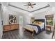 This main bedroom boasts stylish tray ceilings, wood floors, and a bright ensuite bathroom at 2909 Moss Bridge Ln., Myrtle Beach, SC 29579