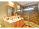 Bathroom features a double sink vanity and walk-in shower with neutral-toned tile at 305 Goddard Ln., Murrells Inlet, SC 29576