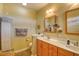 Bright bathroom with double sinks, wooden cabinets, and neutral-toned walls at 305 Goddard Ln., Murrells Inlet, SC 29576