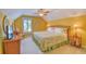 Cozy yellow bedroom features a ceiling fan and a large decorative mirror and sailboat on the dresser at 305 Goddard Ln., Murrells Inlet, SC 29576