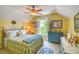 Yellow bedroom with window and shutter, and a blue dresser with a large painting hanging above it at 305 Goddard Ln., Murrells Inlet, SC 29576