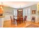 Bright dining room with hardwood floors, a decorative chandelier, and adjacent to the kitchen at 305 Goddard Ln., Murrells Inlet, SC 29576