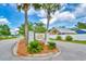 Welcoming neighborhood entrance with the 'Oak Hampton' sign framed by palm trees and landscaped island at 305 Goddard Ln., Murrells Inlet, SC 29576