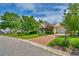 Charming yellow home with a manicured lawn, brick driveway, and an attached garage, creating curb appeal at 305 Goddard Ln., Murrells Inlet, SC 29576