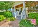 Charming front porch with rocking chairs, manicured landscaping, and inviting entryway at 305 Goddard Ln., Murrells Inlet, SC 29576