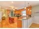 Well-lit kitchen with granite countertops, island seating, and wooden cabinets at 305 Goddard Ln., Murrells Inlet, SC 29576