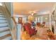 Open-concept living room with staircase, fireplace, and elegant furnishings at 305 Goddard Ln., Murrells Inlet, SC 29576