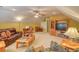 Spacious living room area with a large leather couch, TV, and comfy arm chairs at 305 Goddard Ln., Murrells Inlet, SC 29576