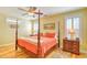 Serene main bedroom with a four-poster bed, ceiling fan, and hardwood floors at 305 Goddard Ln., Murrells Inlet, SC 29576