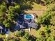 Aerial view of a charming home with a private pool, surrounded by lush greenery and a fenced backyard at 3173 Long Avenue Ext., Conway, SC 29526