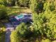 Expansive aerial view of the property featuring a pool, surrounded by a lush green landscape at 3173 Long Avenue Ext., Conway, SC 29526