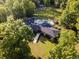 Aerial view showcasing the home's layout, including a pool and beautifully landscaped yard surrounded by trees at 3173 Long Avenue Ext., Conway, SC 29526