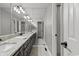 Long bathroom featuring a large counter with double sinks, modern fixtures and a large mirror at 3173 Long Avenue Ext., Conway, SC 29526